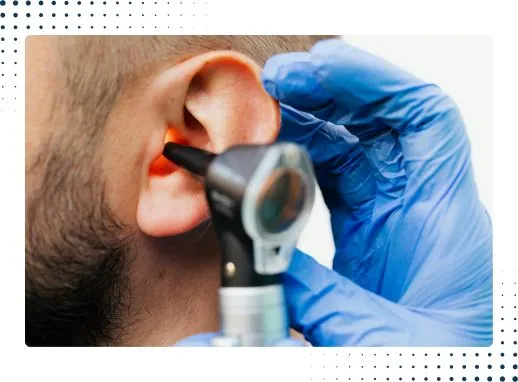 Close view of microsuction ear wax removal procedure in a clinical setting